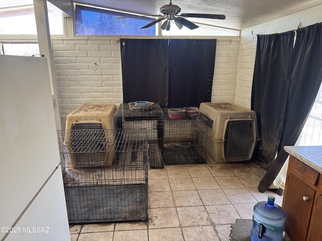 206 W Blacklidge Dr, Tucson, AZ 85705 - detailed view of a ceiling fan, a textured ceiling, and brick wall