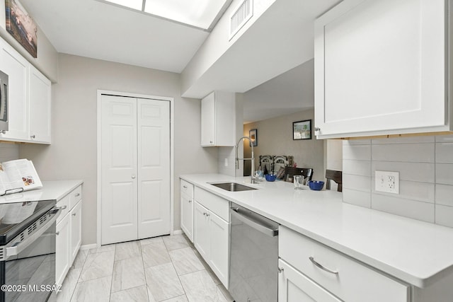 4211 N Villas Placitas, Tucson, AZ 85705 - kitchen with stainless steel appliances, light countertops, white cabinets, and light marble finish flooring
