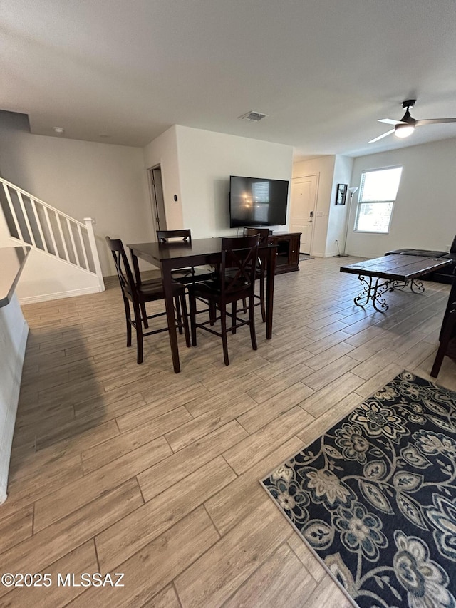 1126 E Descent St, Tucson, AZ 85719 - dining area featuring light wood-style flooring, stairs, and ceiling fan