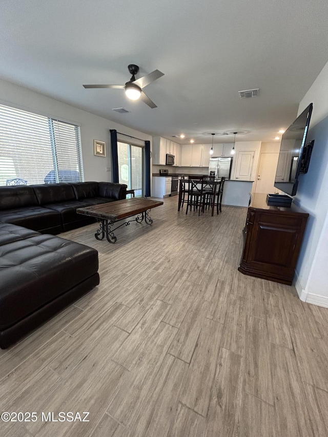 1126 E Descent St, Tucson, AZ 85719 - living area featuring light wood-style flooring and a ceiling fan