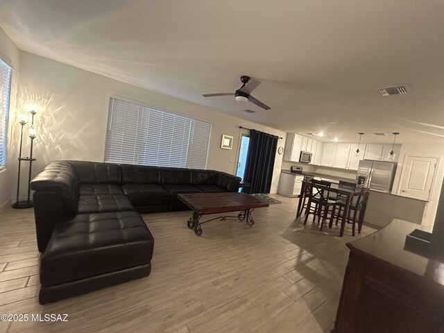 1126 E Descent St, Tucson, AZ 85719 - living room featuring light wood-type flooring and a ceiling fan