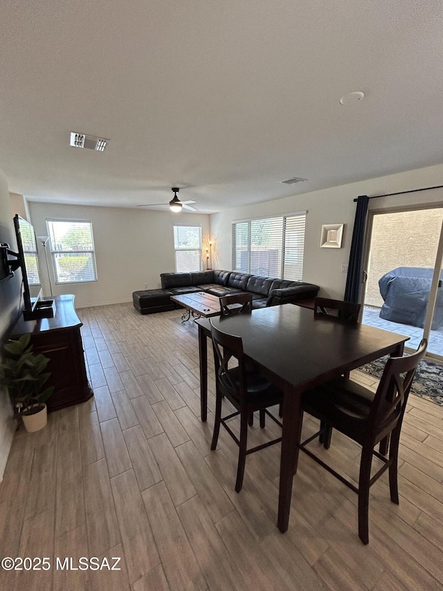 1126 E Descent St, Tucson, AZ 85719 - dining space with wood finished floors, ceiling fan, and plenty of natural light