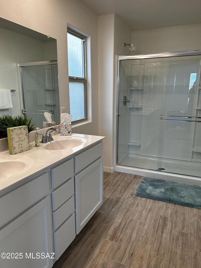 1126 E Descent St, Tucson, AZ 85719 - bathroom with wood finished floors, a stall shower, and double vanity