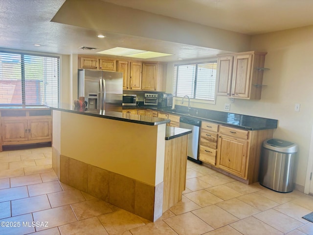 6100 N La Canada Dr, Tucson, AZ 85704 - kitchen with appliances with stainless steel finishes, dark countertops, light tile patterned floors, recessed lighting, and a kitchen island