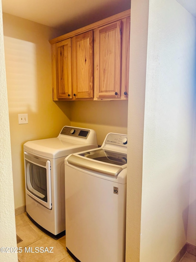 6100 N La Canada Dr, Tucson, AZ 85704 - laundry room featuring washing machine and clothes dryer, cabinet space, and light tile patterned floors
