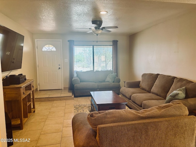 6100 N La Canada Dr, Tucson, AZ 85704 - living room with a textured ceiling, ceiling fan, and light tile patterned floors