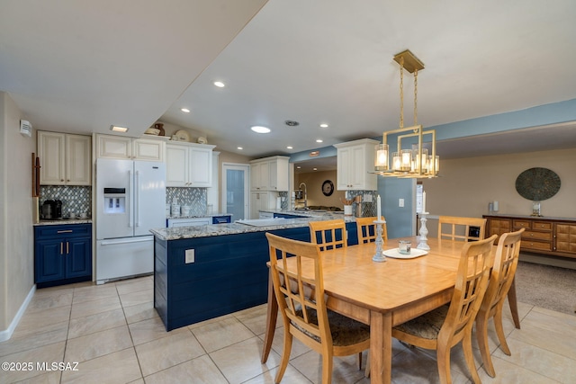 6951 E Hayne Pl, Tucson, AZ 85710 - dining area with light tile patterned floors, recessed lighting, vaulted ceiling, and a chandelier