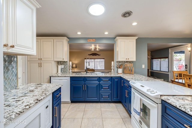 6951 E Hayne Pl, Tucson, AZ 85710 - kitchen with electric range, blue cabinetry, tasteful backsplash, light tile patterned floors, and recessed lighting