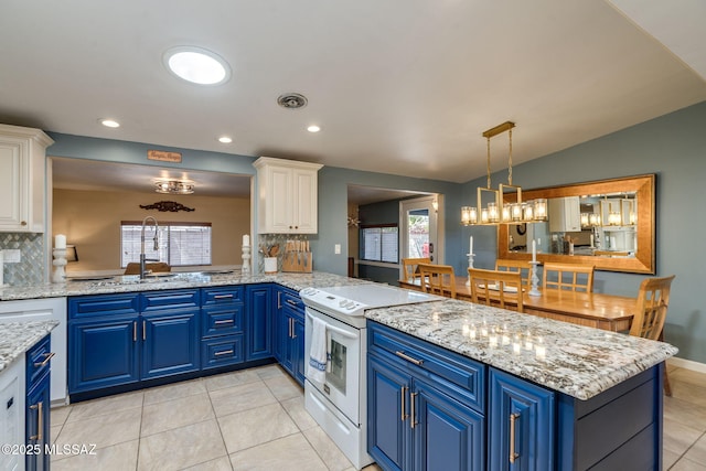 6951 E Hayne Pl, Tucson, AZ 85710 - kitchen with electric range, blue cabinets, white cabinets, light tile patterned flooring, and a peninsula