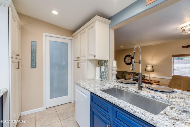 6951 E Hayne Pl, Tucson, AZ 85710 - kitchen with blue cabinetry, white dishwasher, white cabinets, light tile patterned floors, and open floor plan