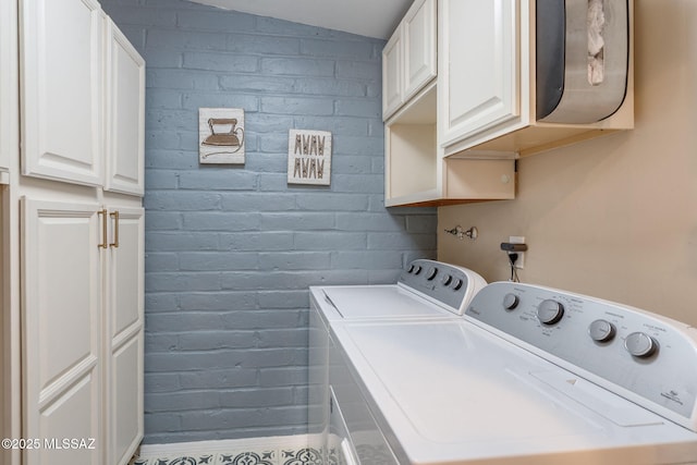 6951 E Hayne Pl, Tucson, AZ 85710 - washroom featuring cabinet space, washer and dryer, and brick wall