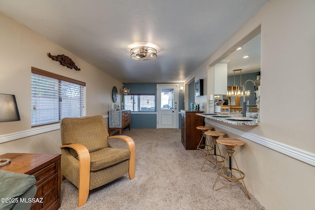 6951 E Hayne Pl, Tucson, AZ 85710 - living area featuring light colored carpet and a chandelier