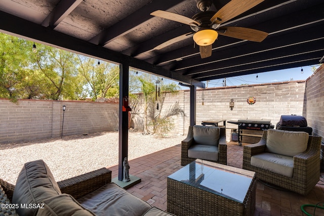 6951 E Hayne Pl, Tucson, AZ 85710 - fenced backyard featuring an outdoor hangout area, a patio area, and a ceiling fan