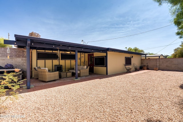 6951 E Hayne Pl, Tucson, AZ 85710 - rear view of house with an outdoor hangout area and a patio area