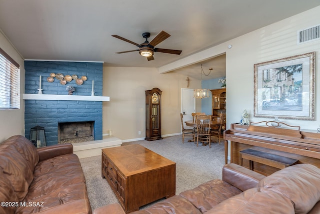 6951 E Hayne Pl, Tucson, AZ 85710 - living room featuring a ceiling fan, carpet, a large fireplace, and beamed ceiling