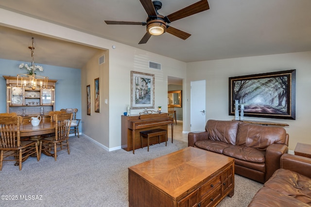 6951 E Hayne Pl, Tucson, AZ 85710 - living room featuring a ceiling fan, light colored carpet, and a chandelier