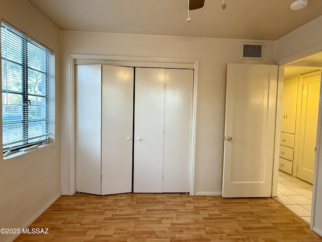 1412 E Silver St, Tucson, AZ 85719 - unfurnished bedroom with light wood-style flooring and a closet