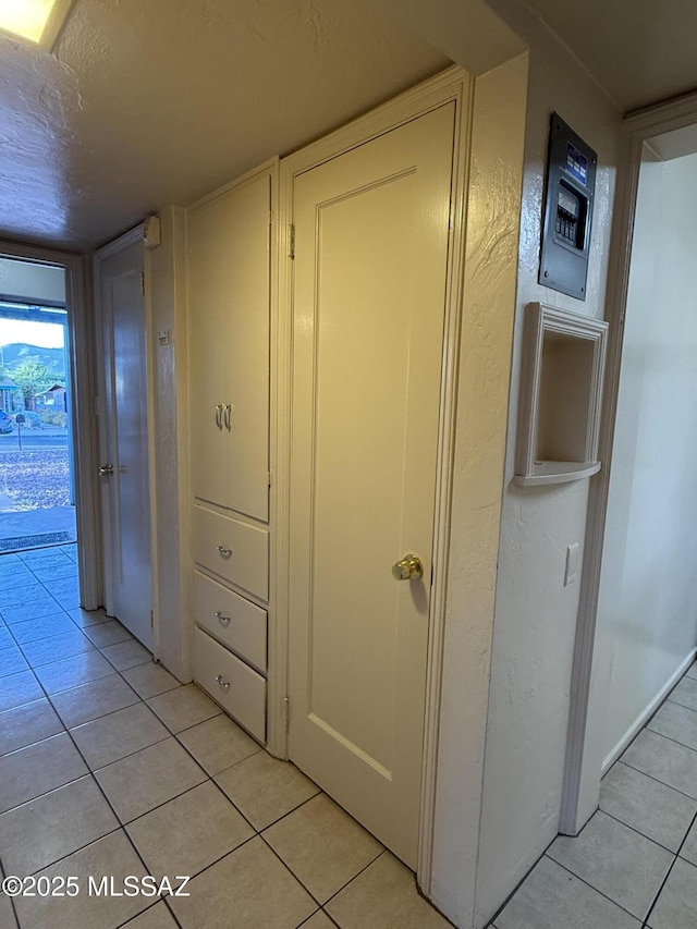 1412 E Silver St, Tucson, AZ 85719 - corridor featuring light tile patterned floors and a textured ceiling