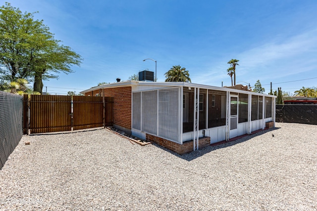 1435 E Grant Rd, Tucson, AZ 85719 - view of side of home featuring a sunroom and a gate
