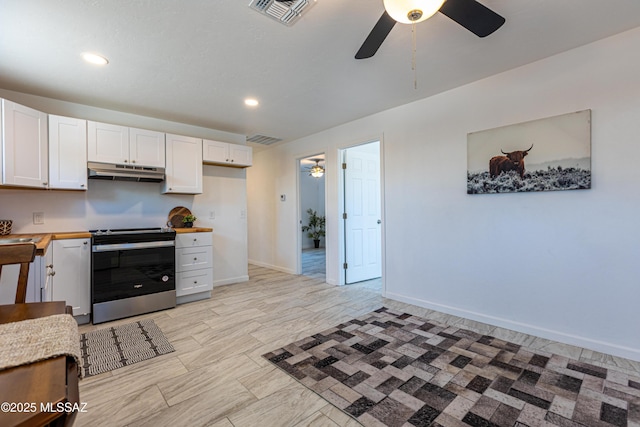 1435 E Grant Rd, Tucson, AZ 85719 - kitchen featuring stainless steel electric range oven, under cabinet range hood, a ceiling fan, white cabinetry, and wooden counters