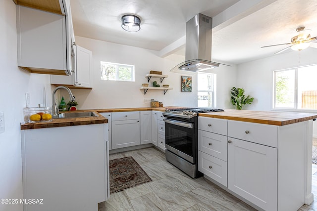 1435 E Grant Rd, Tucson, AZ 85719 - kitchen with butcher block counters, gas range, island exhaust hood, and open shelves