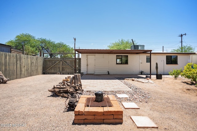 4009 N Fontana Ave, Tucson, AZ 85705 - back of property featuring a gate, an outdoor fire pit, and a patio area