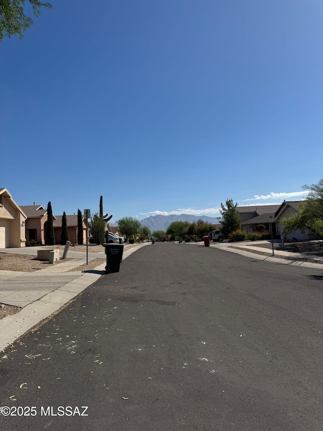 1129 W Amberbrooke Ave, Tucson, AZ 85745 - view of asphalt street featuring sidewalks, curbs, and a mountain view