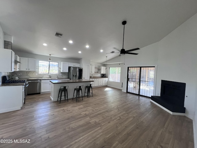 1129 W Amberbrooke Ave, Tucson, AZ 85745 - kitchen with stainless steel appliances, open floor plan, recessed lighting, healthy amount of natural light, and a kitchen breakfast bar