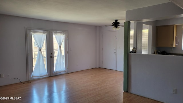 1967 N Camino Serna Unit D, Tucson, AZ 85715 - unfurnished living room with french doors, light wood-type flooring, and a ceiling fan