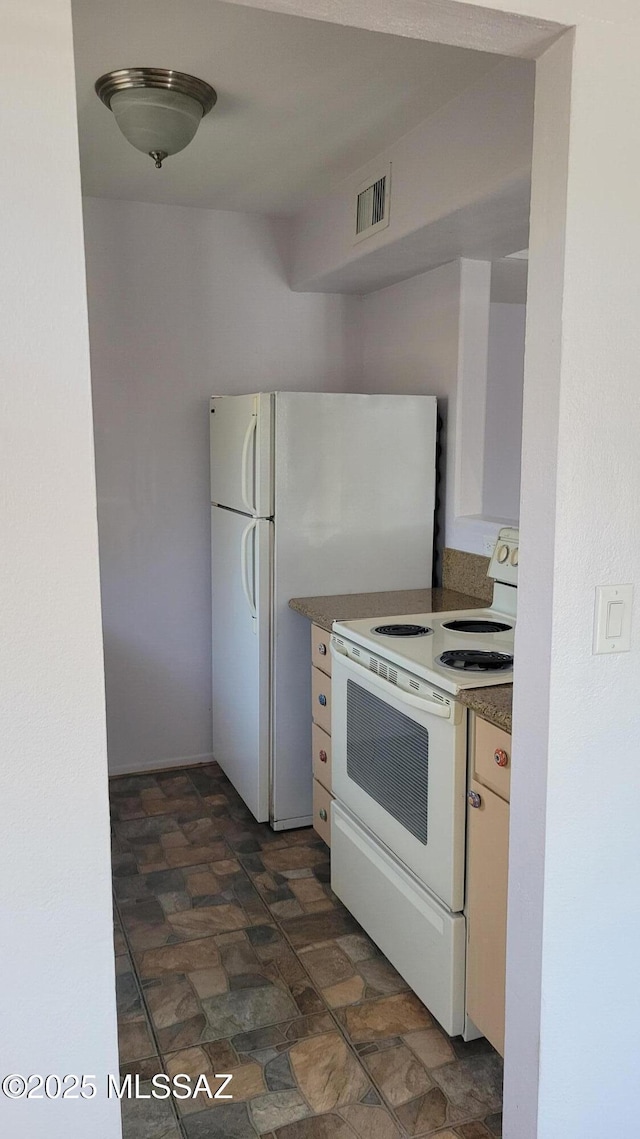 1967 N Camino Serna Unit D, Tucson, AZ 85715 - kitchen featuring white appliances, stone finish floors, and dark countertops