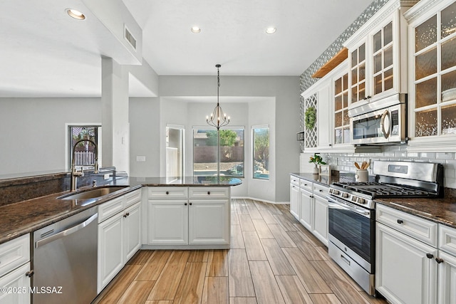 7705 W Taltson Dr, Tucson, AZ 85743 - kitchen featuring stainless steel appliances, recessed lighting, a chandelier, white cabinetry, and light wood-style flooring