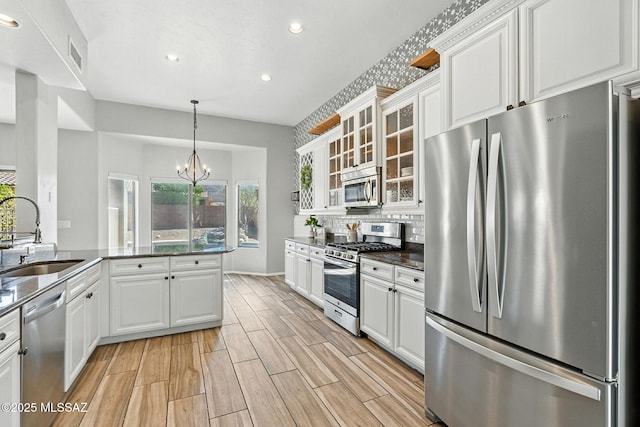 7705 W Taltson Dr, Tucson, AZ 85743 - kitchen featuring stainless steel appliances, recessed lighting, white cabinetry, plenty of natural light, and glass insert cabinets