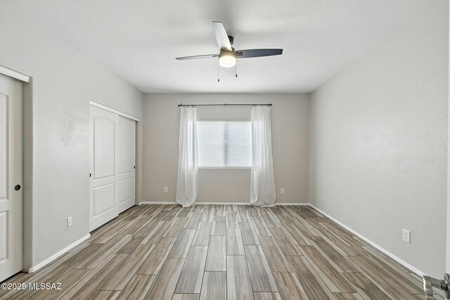 7705 W Taltson Dr, Tucson, AZ 85743 - unfurnished bedroom with wood finished floors, a closet, and ceiling fan