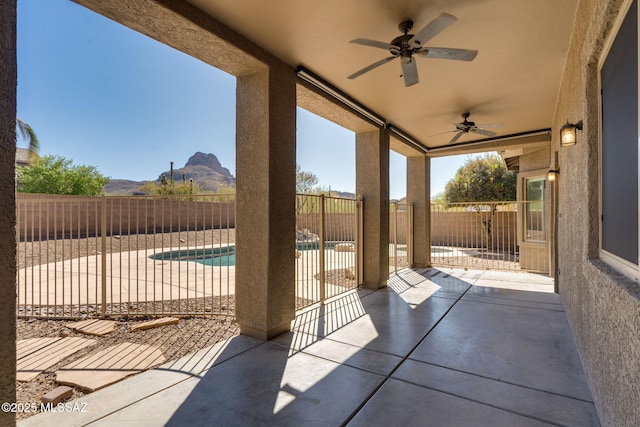 7705 W Taltson Dr, Tucson, AZ 85743 - fenced backyard with ceiling fan, a patio, and a mountain view