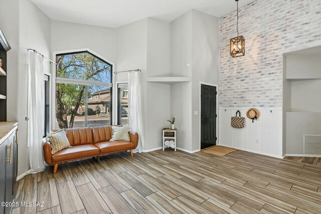 7705 W Taltson Dr, Tucson, AZ 85743 - sitting room featuring high vaulted ceiling, light wood-type flooring, and a chandelier