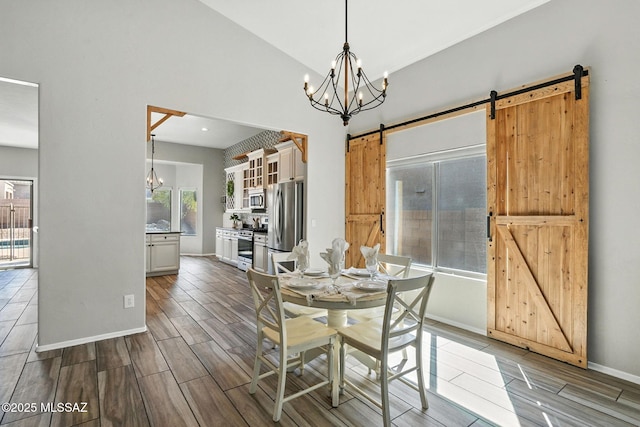 7705 W Taltson Dr, Tucson, AZ 85743 - dining area with a barn door, a chandelier, and wood finish floors
