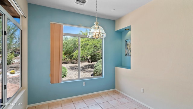 2315 E Chrysanthemum St, Oro Valley, AZ 85755 - unfurnished dining area featuring plenty of natural light, a chandelier, and tile patterned floors