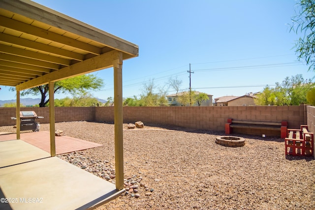 9495 N Winter Wren Ave, Tucson, AZ 85742 - fenced backyard with a fire pit and a patio