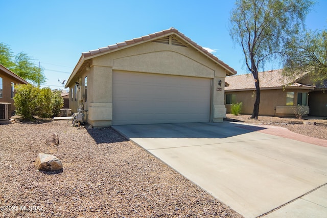 9495 N Winter Wren Ave, Tucson, AZ 85742 - ranch-style home with driveway, stucco siding, a garage, and a tiled roof