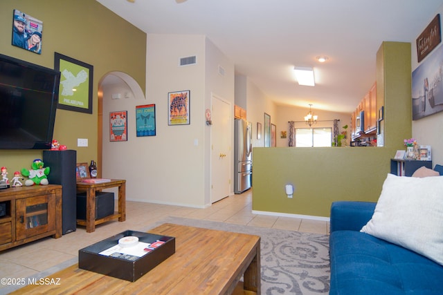 9495 N Winter Wren Ave, Tucson, AZ 85742 - living room featuring light tile patterned floors and arched walkways