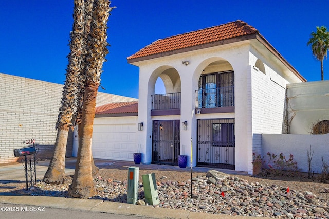 1310 N Dorado Blvd, Tucson, AZ 85715 - view of front of property with a tile roof, a garage, a balcony, and stucco siding