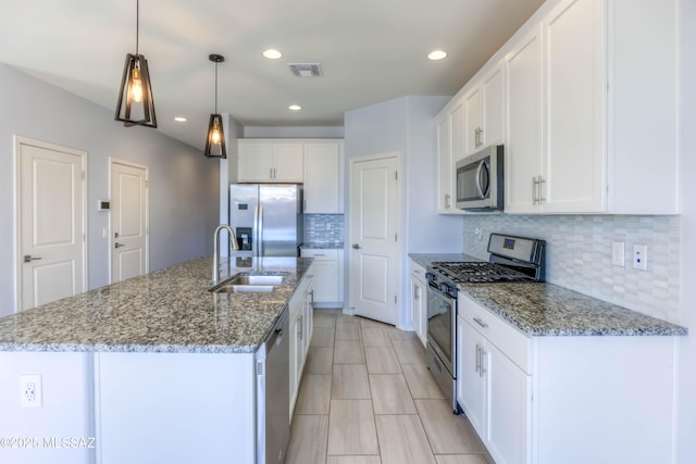 13114 N Grayson Dr, Marana, AZ 85653 - kitchen featuring appliances with stainless steel finishes, tasteful backsplash, white cabinetry, a center island with sink, and recessed lighting