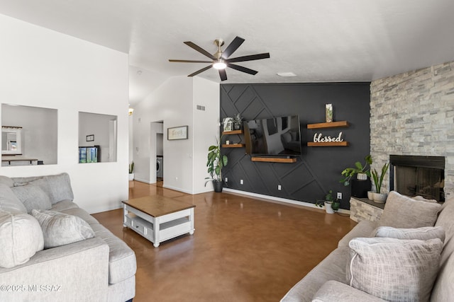 10636 E Malta St, Tucson, AZ 85747 - living room with a ceiling fan, finished concrete flooring, an accent wall, and a fireplace