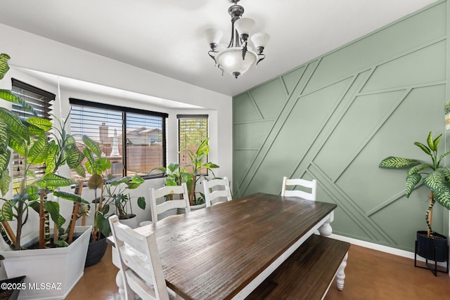 10636 E Malta St, Tucson, AZ 85747 - dining space featuring a decorative wall and a chandelier