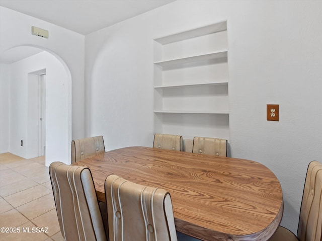 2638 N Wilson Ave, Tucson, AZ 85719 - dining room with arched walkways and light tile patterned flooring