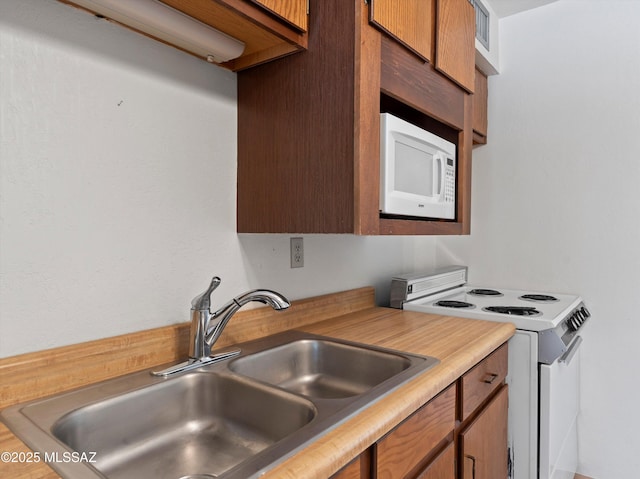 2638 N Wilson Ave, Tucson, AZ 85719 - kitchen featuring white appliances, light countertops, and brown cabinetry