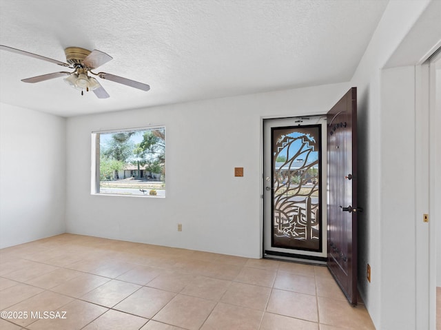 2638 N Wilson Ave, Tucson, AZ 85719 - entryway with light tile patterned flooring, ceiling fan, and a textured ceiling
