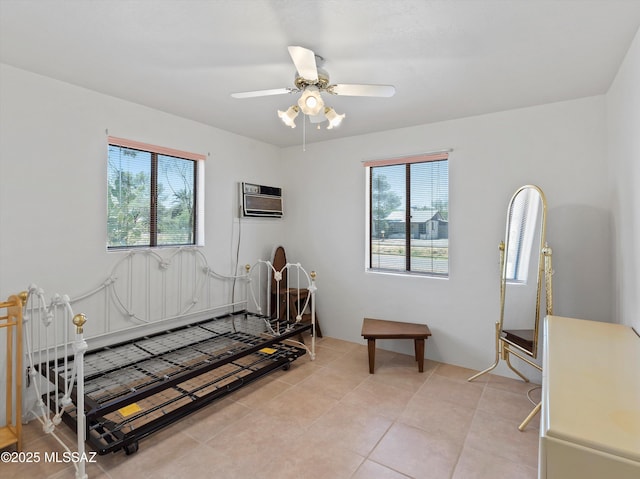 2638 N Wilson Ave, Tucson, AZ 85719 - bedroom featuring multiple windows, light tile patterned floors, a wall unit AC, and a ceiling fan