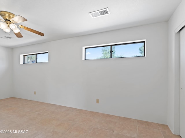 2638 N Wilson Ave, Tucson, AZ 85719 - empty room with healthy amount of natural light, light tile patterned floors, and a ceiling fan