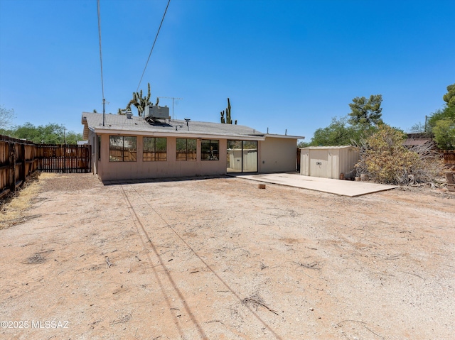 2638 N Wilson Ave, Tucson, AZ 85719 - back of house featuring a patio, a storage shed, and stucco siding
